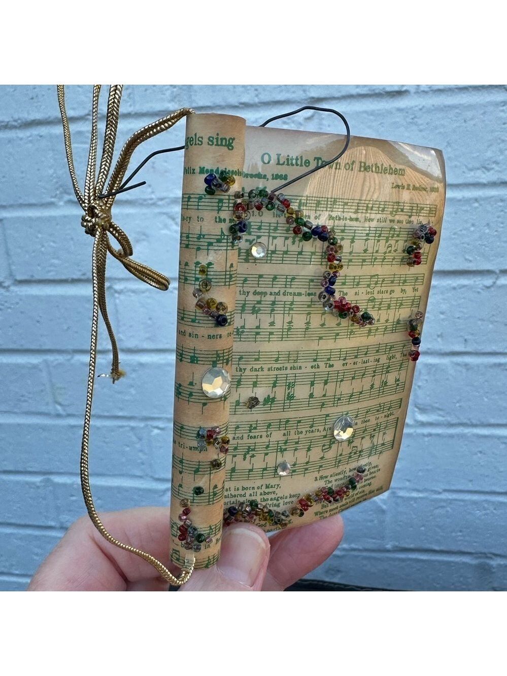 Vintage Sheet Music Ornament Wrapped in Plastic decorated with Beads and Jewels